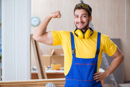 Young repairman carpenter working cutting wood
