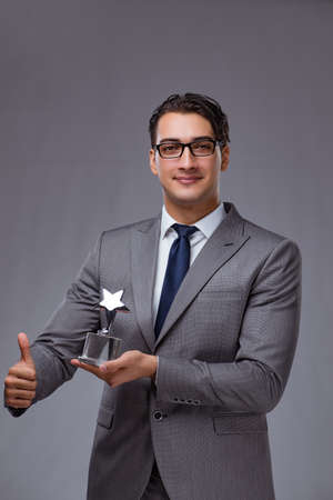 Businessman holding star award in business conceptの写真素材