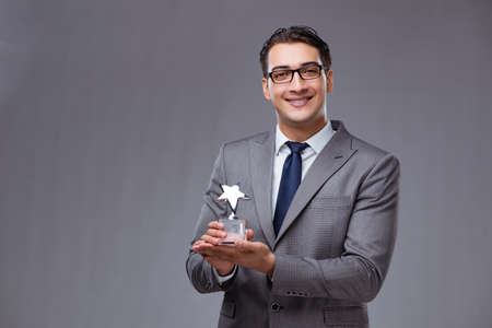 Businessman holding star award in business conceptの写真素材