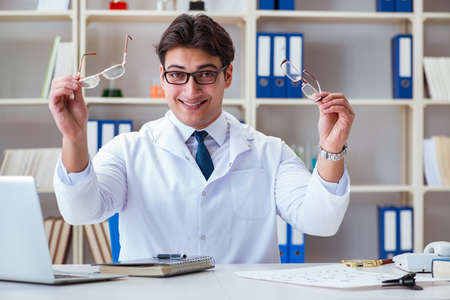Doctor optician prescribing holding optical glassesの写真素材