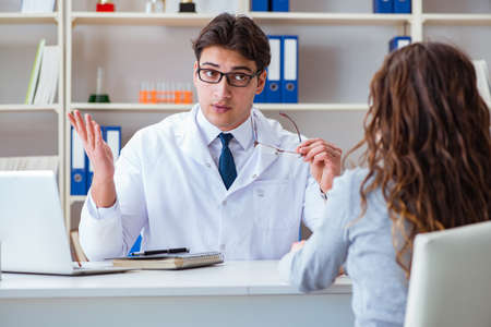 Doctor optician prescribing glasses to a patientの写真素材