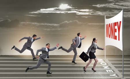 Business people running towards money goalの写真素材