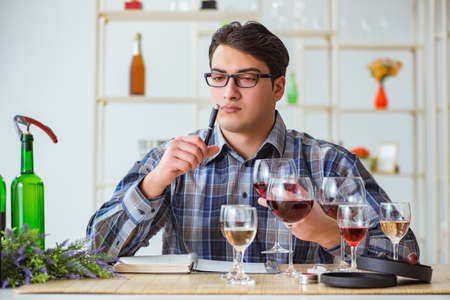 Professional sommelier tasting red wine