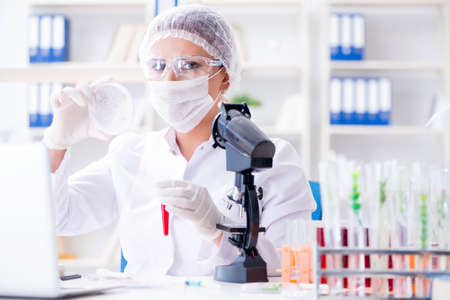 Female scientist researcher conducting an experiment in a laboraの写真素材