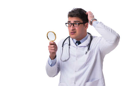 Young male doctor with a looking magnifying glass isolated on whの写真素材