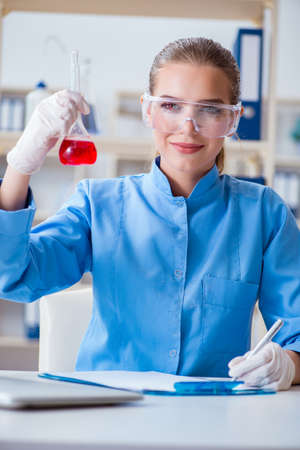 Female scientist researcher conducting an experiment in a laboraの写真素材