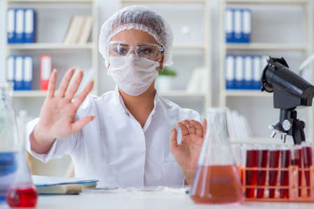 Female scientist researcher conducting an experiment in a laboraの写真素材
