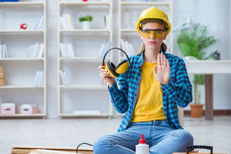 Female repairman carpenter cutting joining wooden planks doing rの写真素材