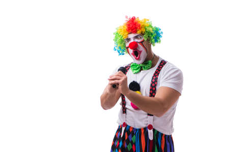 Funny clown with a microphone singing karaoke isolated on whiteの写真素材