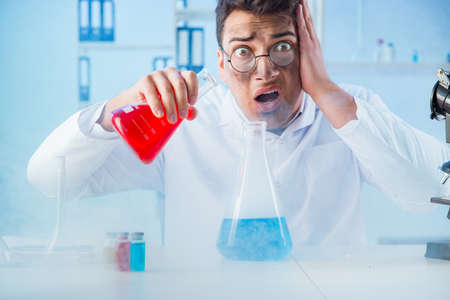 Funny mad chemist working in a laboratoryの写真素材