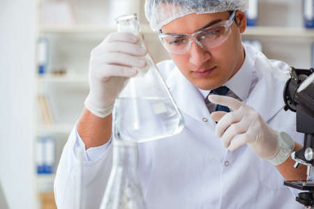 Young researcher scientist doing a water test contamination expeの写真素材
