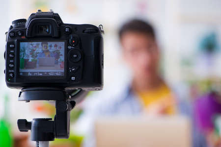 Man florist gardener vlogger blogger shooting video on camera