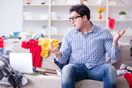 Young man working studying in messy roomの写真素材