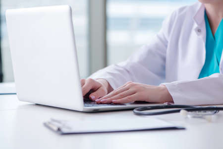 Doctor man working on the computer in labの写真素材