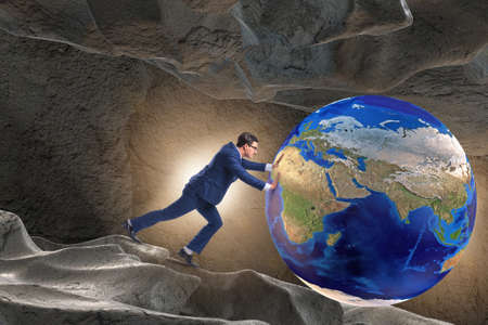 Businessman pushing the world in challenge conceptの写真素材