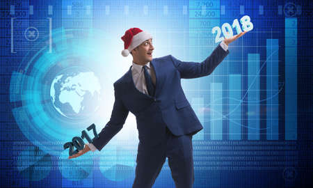 Businessman in santa hat holding 2017 and 2018の写真素材