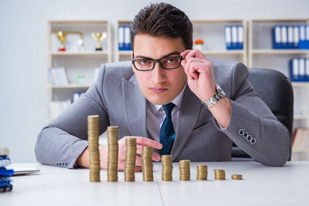 Businessman with golden coins in business growth conceptの写真素材