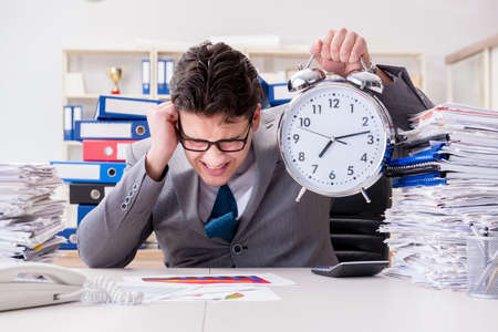 Businessman missing deadlines due to excessive workの写真素材