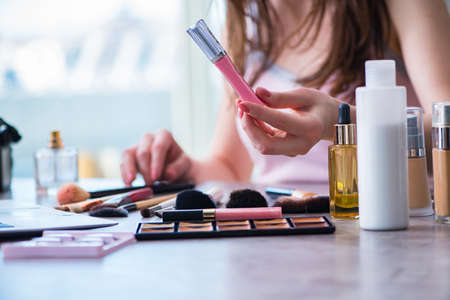 Woman with make-up accessories in beauty conceptの写真素材