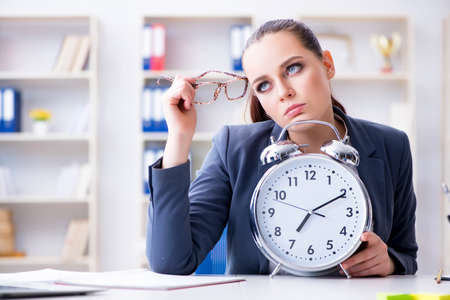 Businesswoman in time management conceptの写真素材