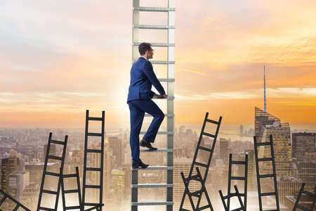 Career concept with businessman climbing ladderの写真素材