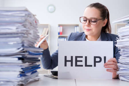Businesswoman pleading for help in officeの写真素材