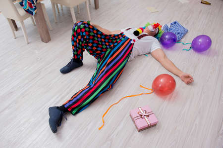 Drunk clown celebrating having a party at homeの写真素材