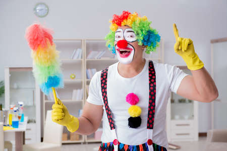Funny clown doing cleaning at home