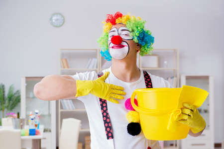Funny clown doing cleaning at homeの写真素材
