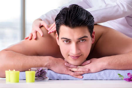 Handsome man in spa massage conceptの写真素材