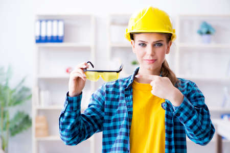 Woman in workshop with protective gogglesの写真素材
