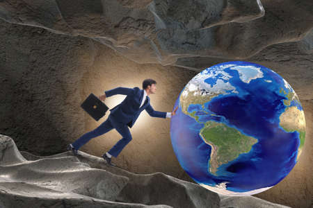 Businessman pushing the world in challenge concept