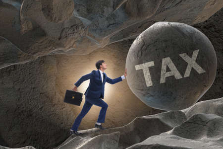 Businessman in high taxes business conceptの写真素材