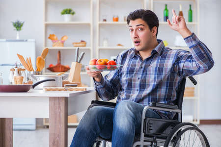 Young disabled husband preparing food saladの写真素材