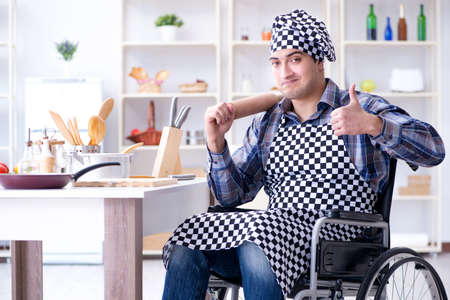 Young cook with roller preparing dough mealの写真素材