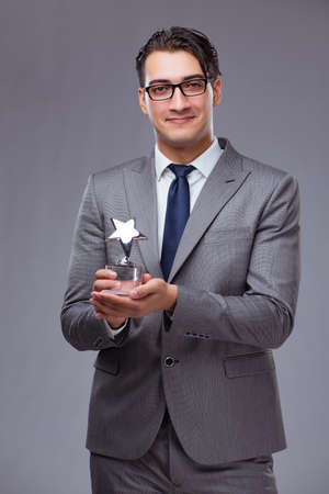 Businessman holding star award in business conceptの写真素材