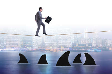 Hand cutting rope in business risk conceptの写真素材