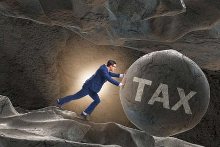 Businessman in high taxes business conceptの写真素材
