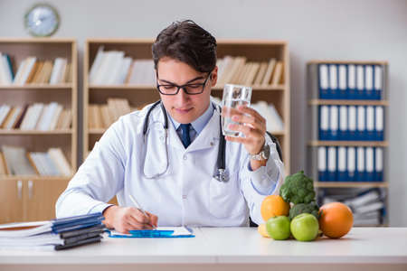 Scientist studying nutrition in various foodの写真素材