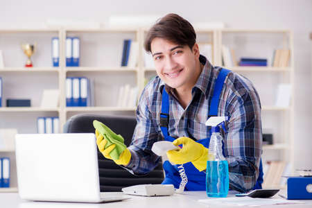 Male cleaner working in the office