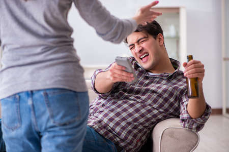 Drinking problem drunk husband man in a young family conceptの写真素材