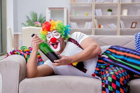 Drunk clown celebrating having a party at homeの写真素材