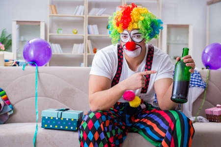 Drunk clown celebrating having a party at homeの写真素材