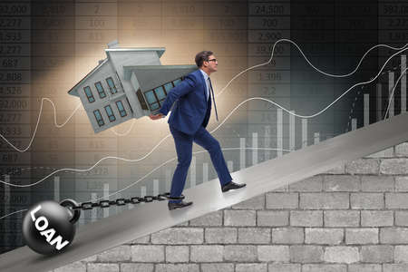 Businessman in mortgage debt financing conceptの写真素材