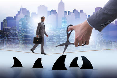 Hand cutting rope in business risk conceptの写真素材