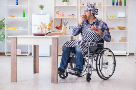 Young disabled husband preparing food saladの写真素材
