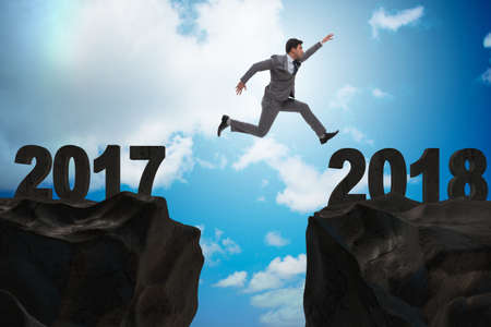Businessman looking forward to 2018 from 2017の写真素材