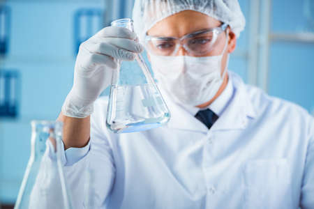 Female scientist researcher conducting an experiment in a labora