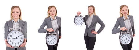 Businesswoman in gray suit holding alarm clock isolated on whiteの写真素材