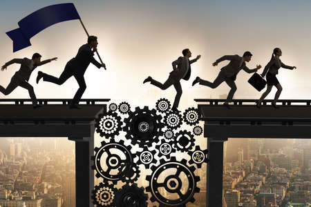 Business people crossing the bridge with cogwheelsの写真素材